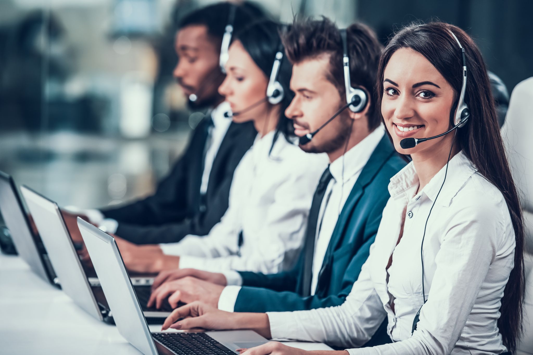 Multicultural young happy employees in call center
